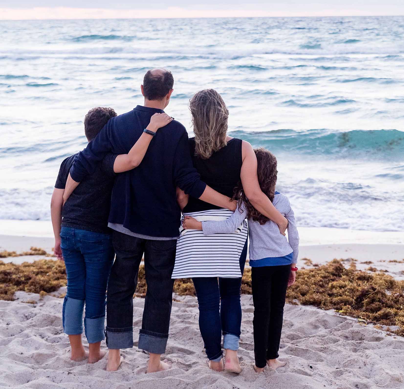 family walking on beach together