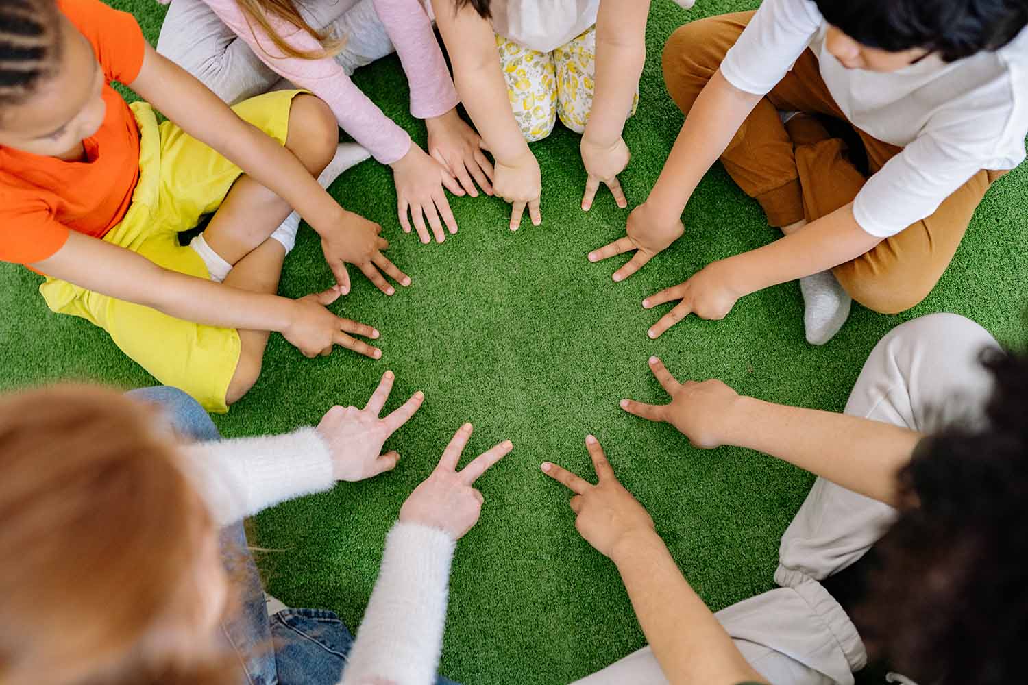 children sat in circle playing game